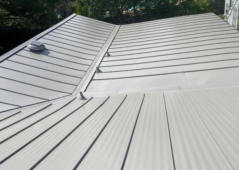 Solar attic fan installed on a metal roof for Roof Ventilation in Houma